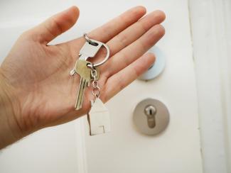 Hand holding a house key